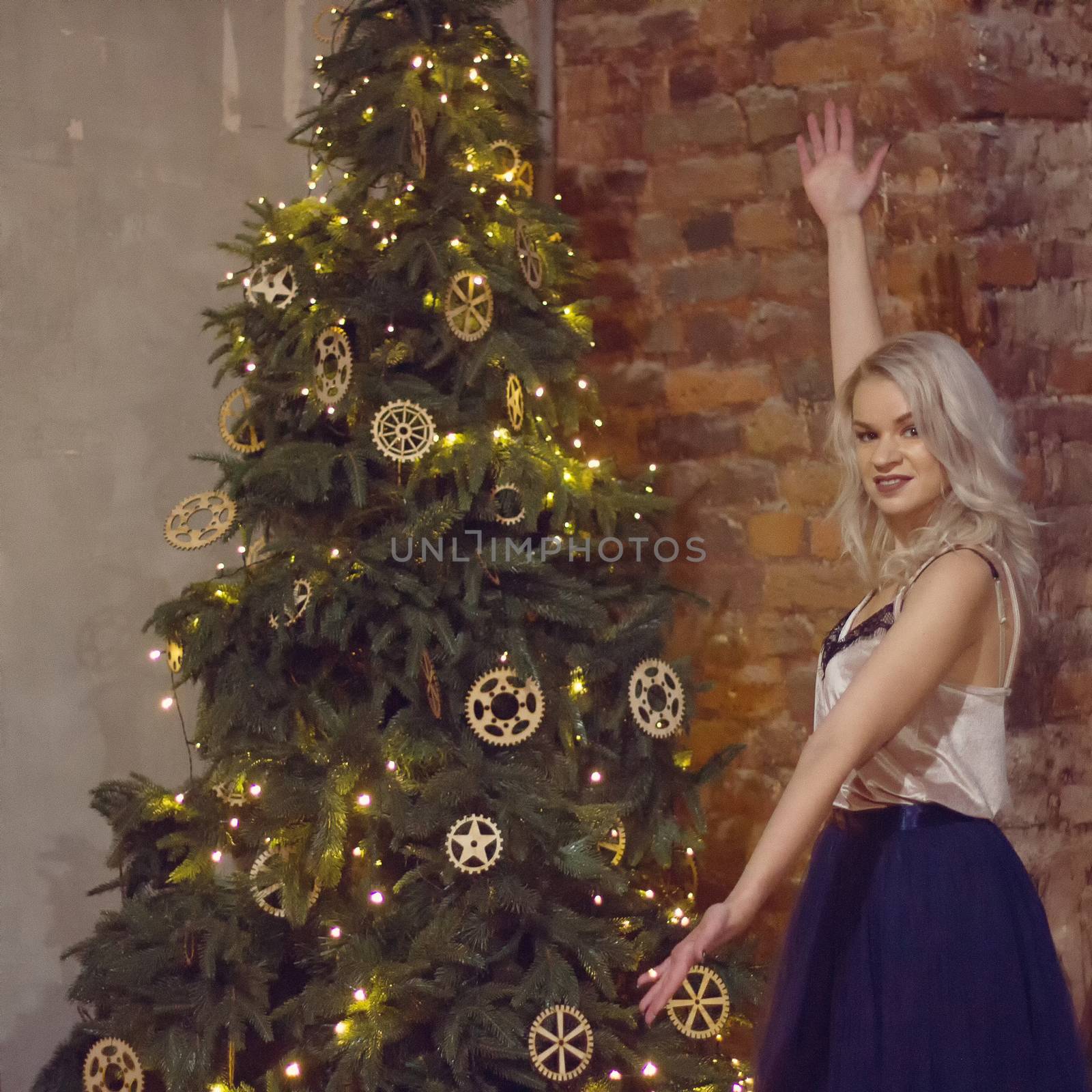 stylish happy woman decorating christmas tree.seasonal greetings concept