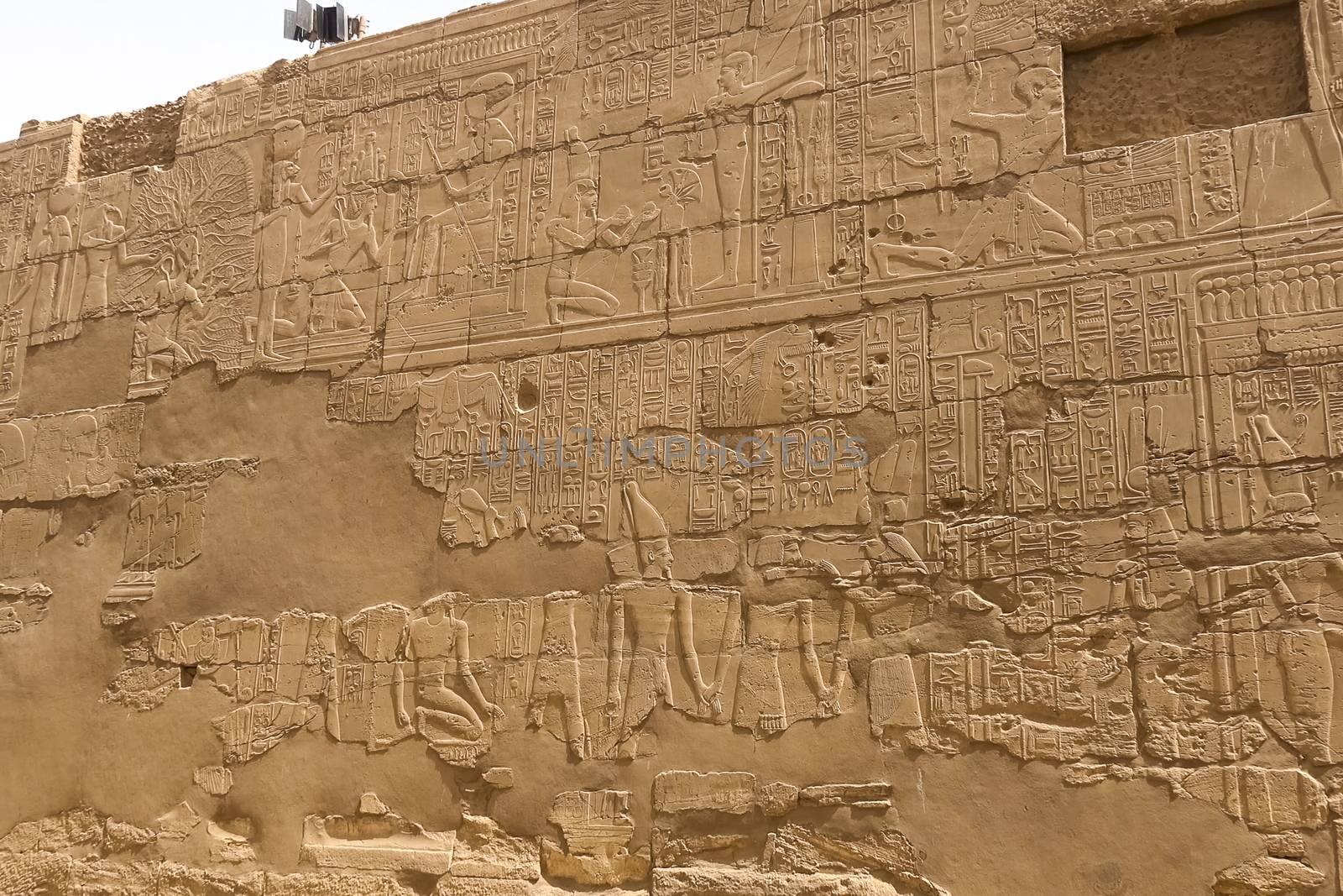 Egyptian hieroglyphs and drawings on the walls and columns. Egyptian language, The life of ancient gods and people in hieroglyphics and drawings