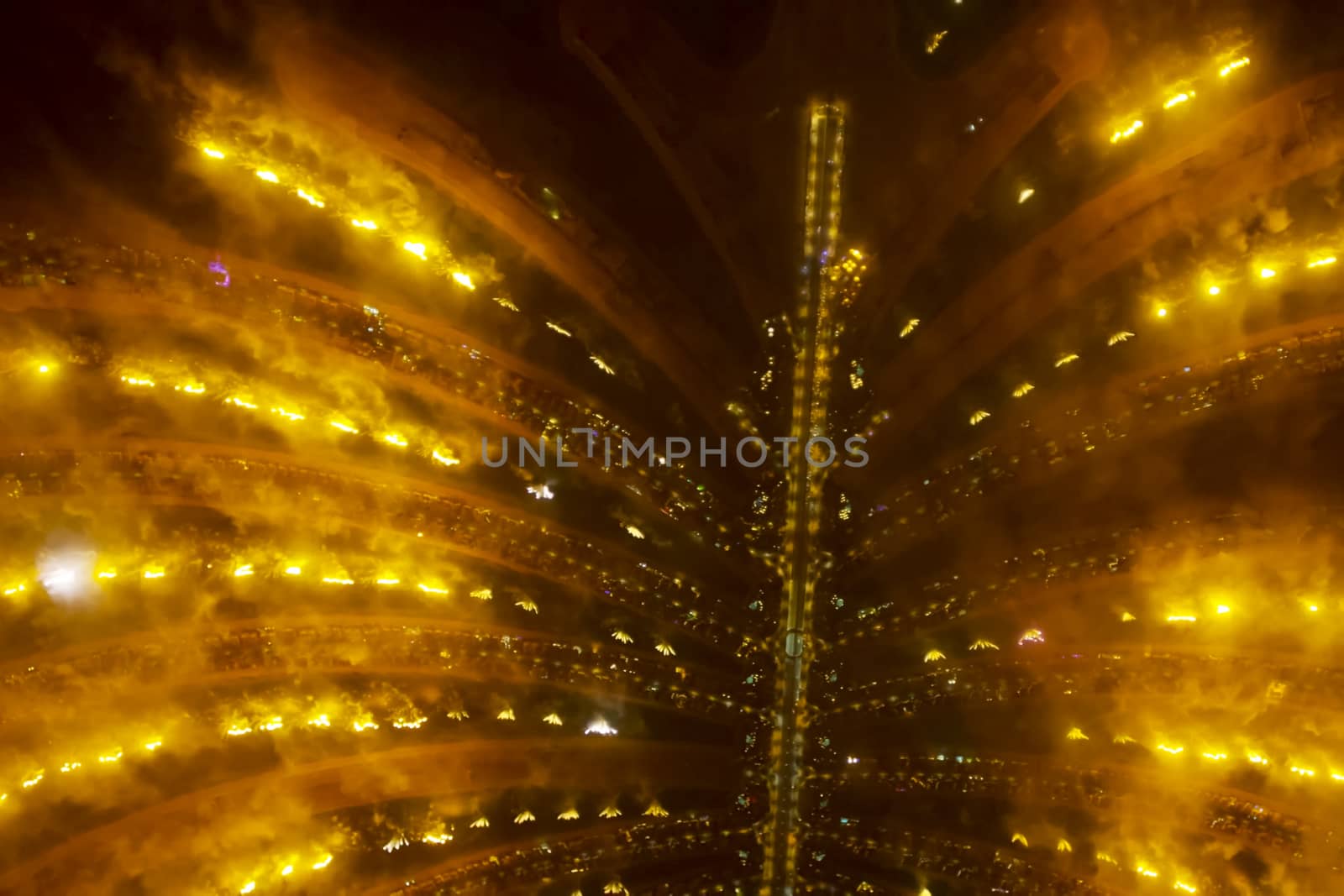 Festive firework in Dubai. Beautiful colorful holiday fireworks in the evening sky with majestic clouds, long exposure