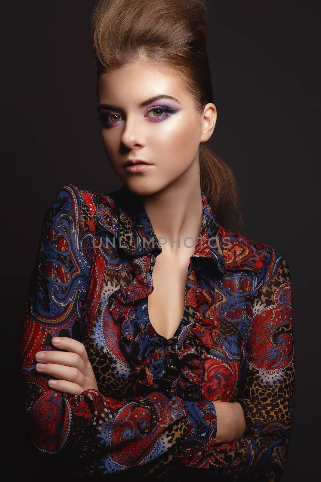Studio Portrait of a beautiful young model girl with glamorous evening makeup