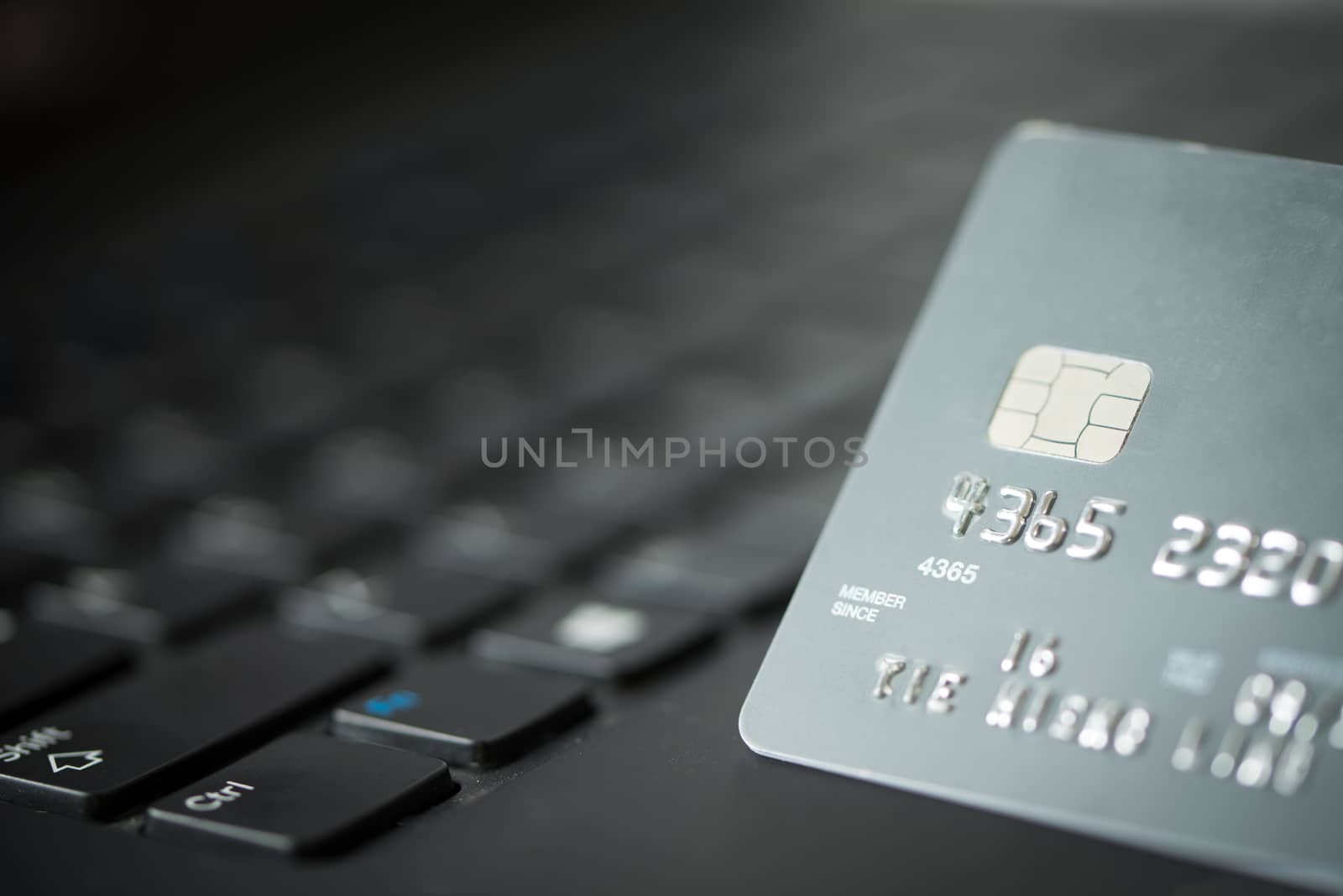 Credit card on laptop for online payment or shopping concept