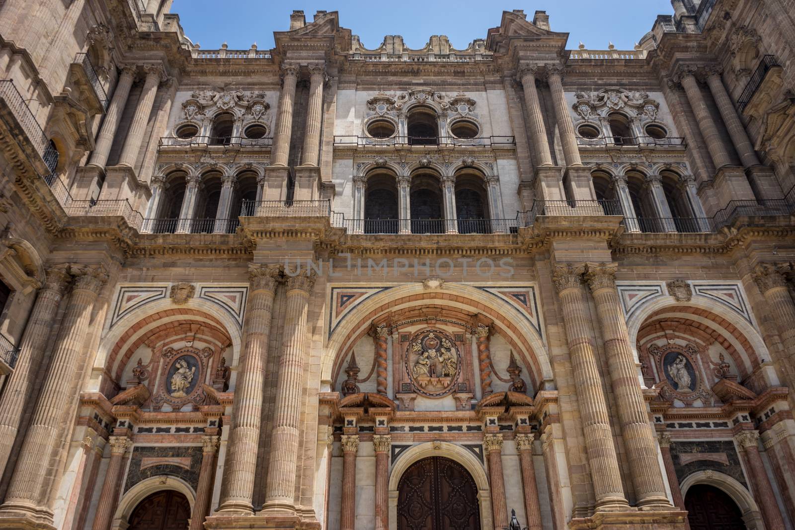 Baroque design of the main doors to the Malaga Cathedral in Malaga, Andalusia, Spain, Europe on a bright summer day