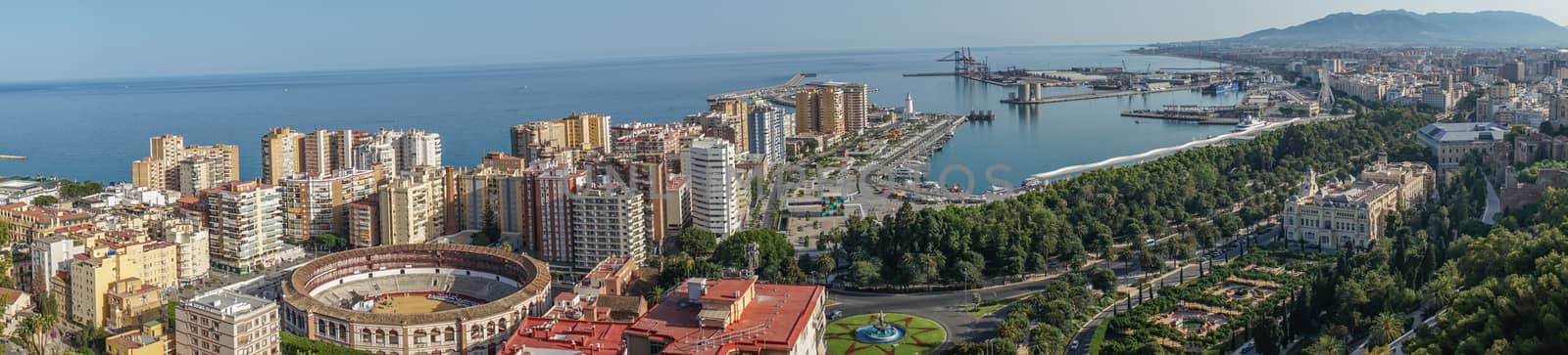 Panorama City skyline and harbour, sea port, bullring of Malaga overlooking the sea ocean in Malaga, Spain, Europe  on a summer day with blue sky