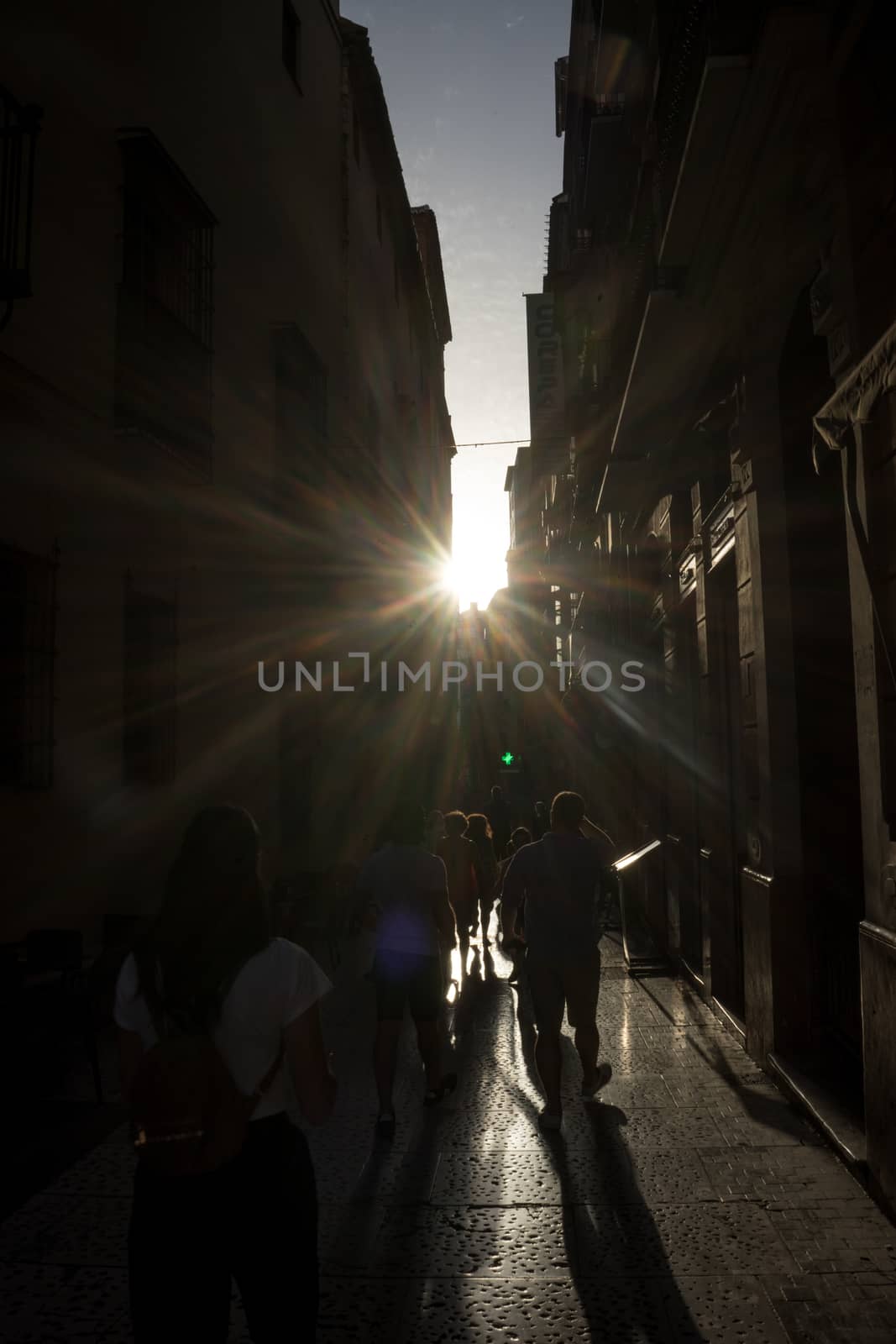 The golden sun sets across the streets of Malaga, Spain, Europe on a summer day