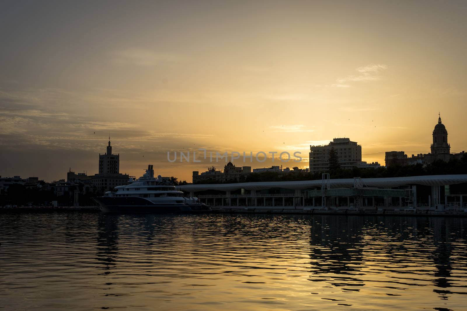 The docking harbour of Malaga with sun set in the background in Malaga, Spain, Europe at the golden hour