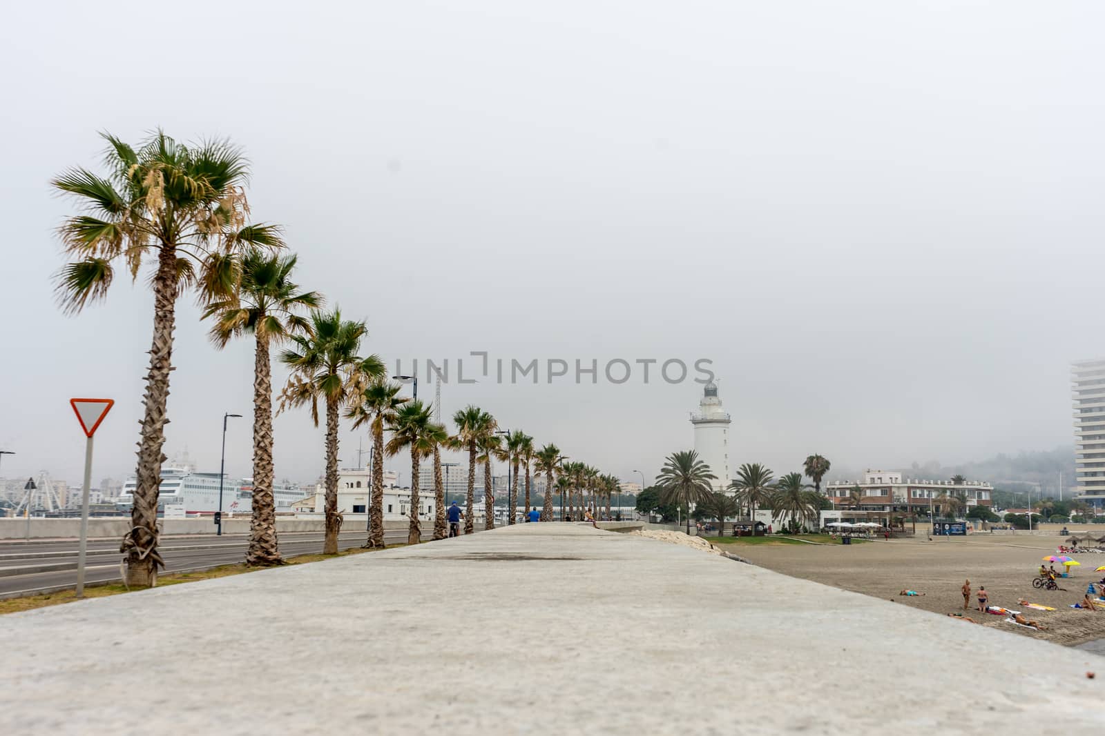 The lighthouse at Malagueta beach in Malaga, Spain, Europe on a cloudy morning