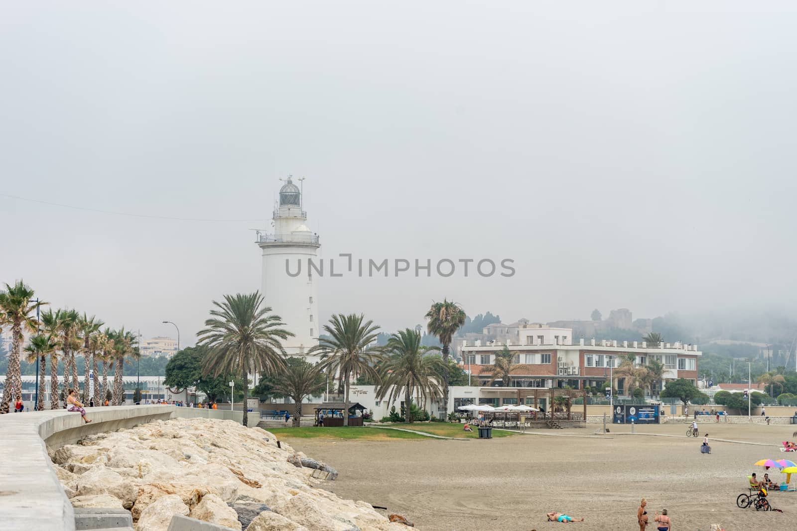 The lighthouse at Malagueta beach in Malaga, Spain, Europe on a cloudy morning