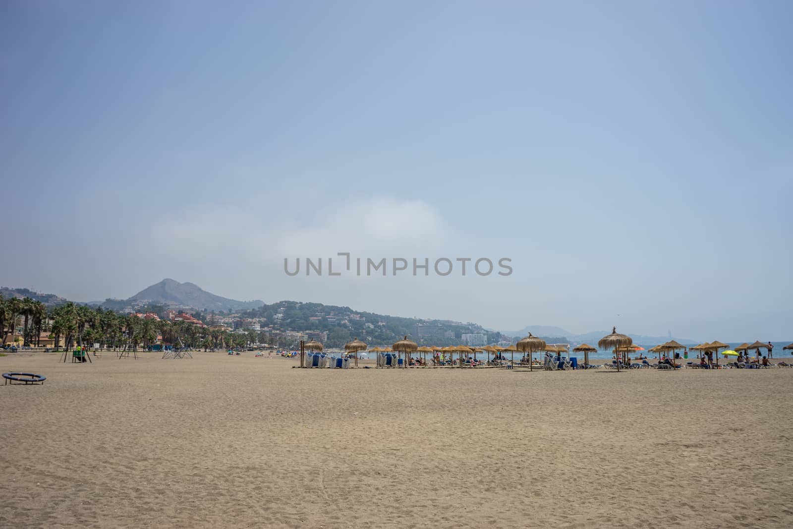 A hill overlooking the sandy Malagueta beach at Malaga, Spain, Europe on a cloudy morning