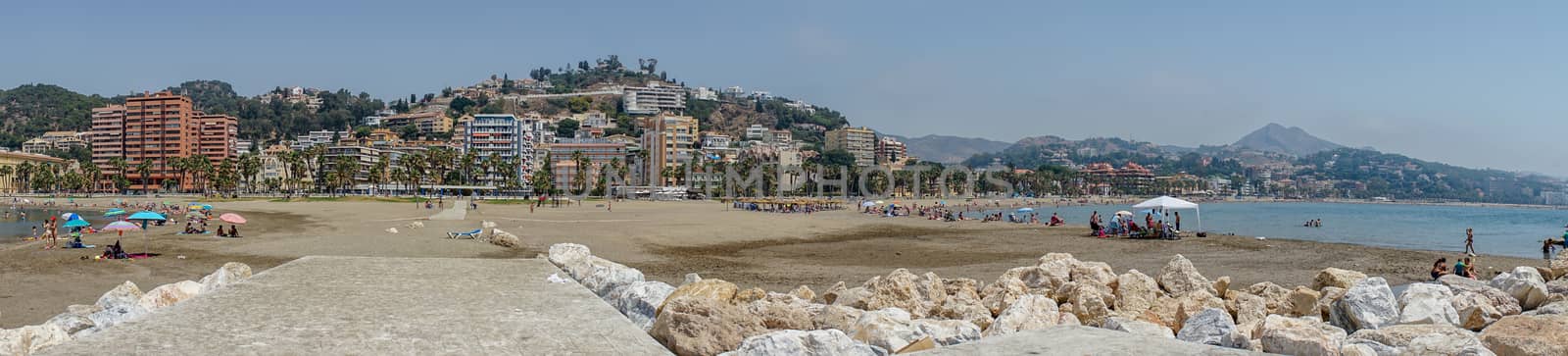 Panoramic view of the ocean at Malagueta beach with rocks at Malaga, Spain, Europe on a clear sky morning