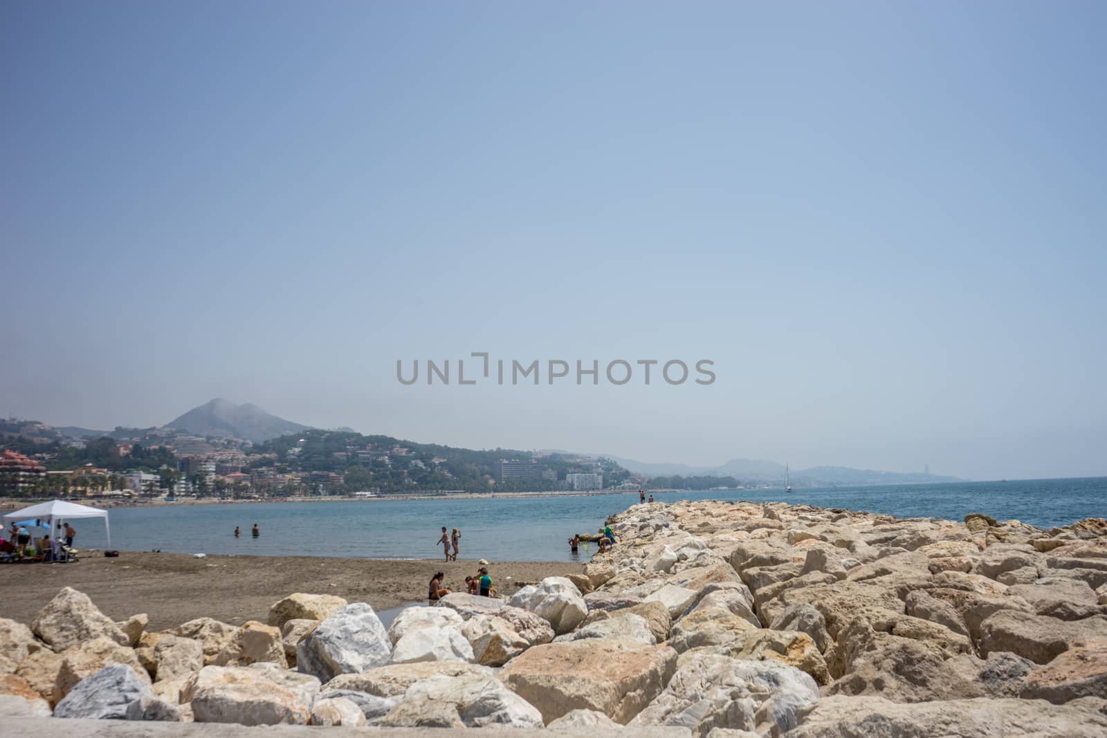 View of the ocean at Malagueta beach with rocks at Malaga, Spain by ramana16