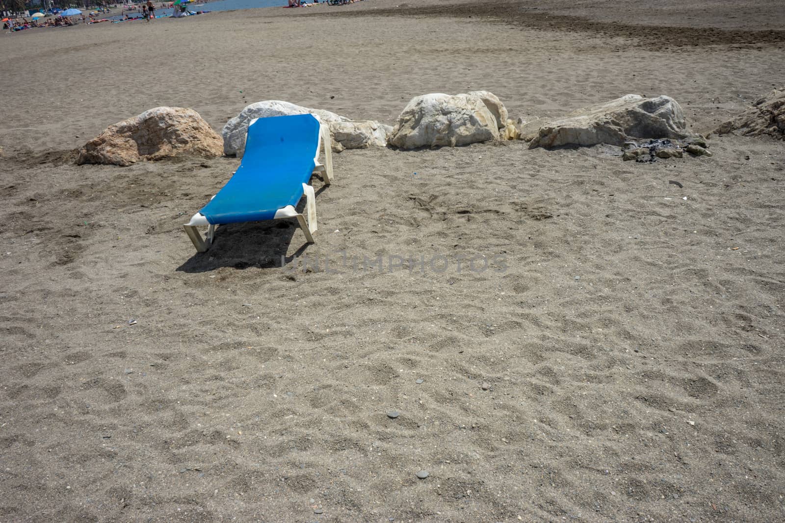 Sunbed on the rocky beack at Malagueta in Malaga, Spain, Europe on a cloudy morning