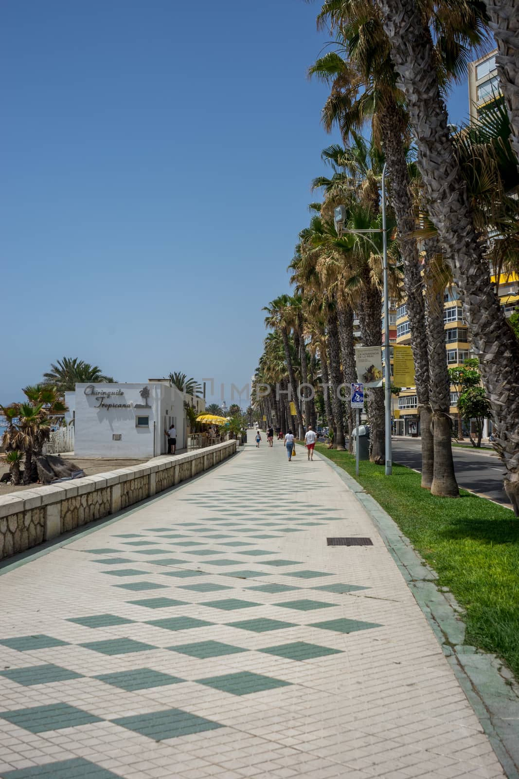 Pathway along the malagueta beach at Malaga, Spain, Europe on a bright summer day wih clear blue skies