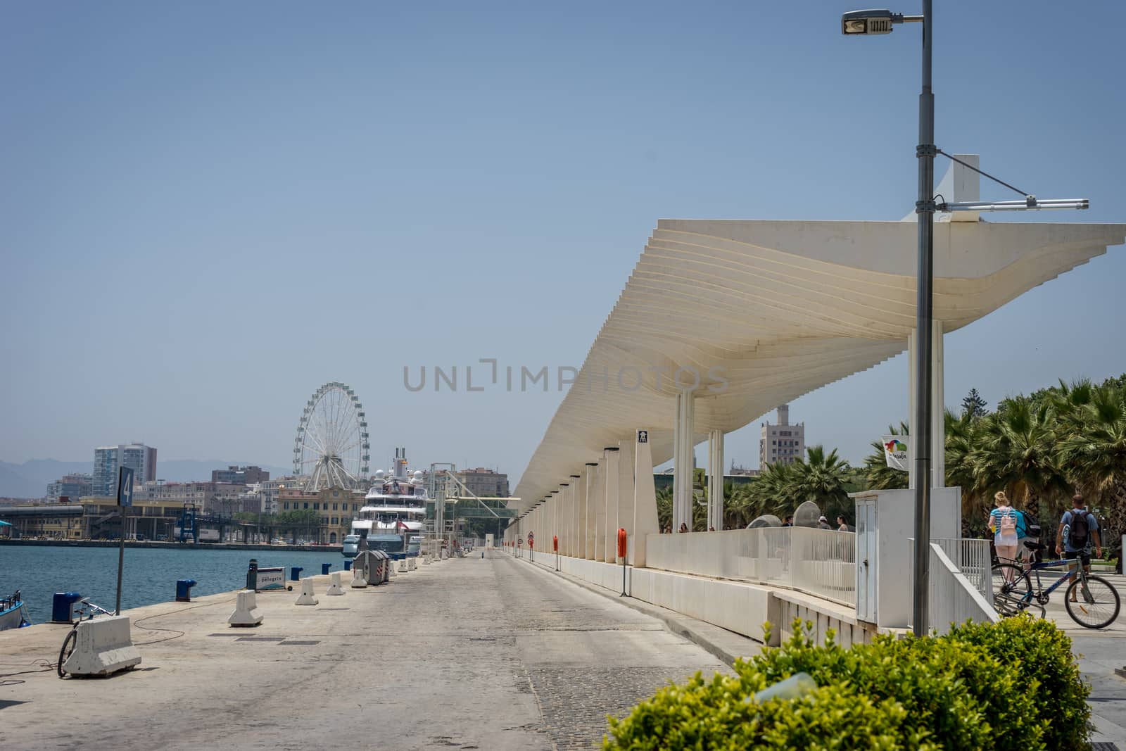 A giant wheel alongside the beach in Malaga, Spain, Europe on a bright summer morning