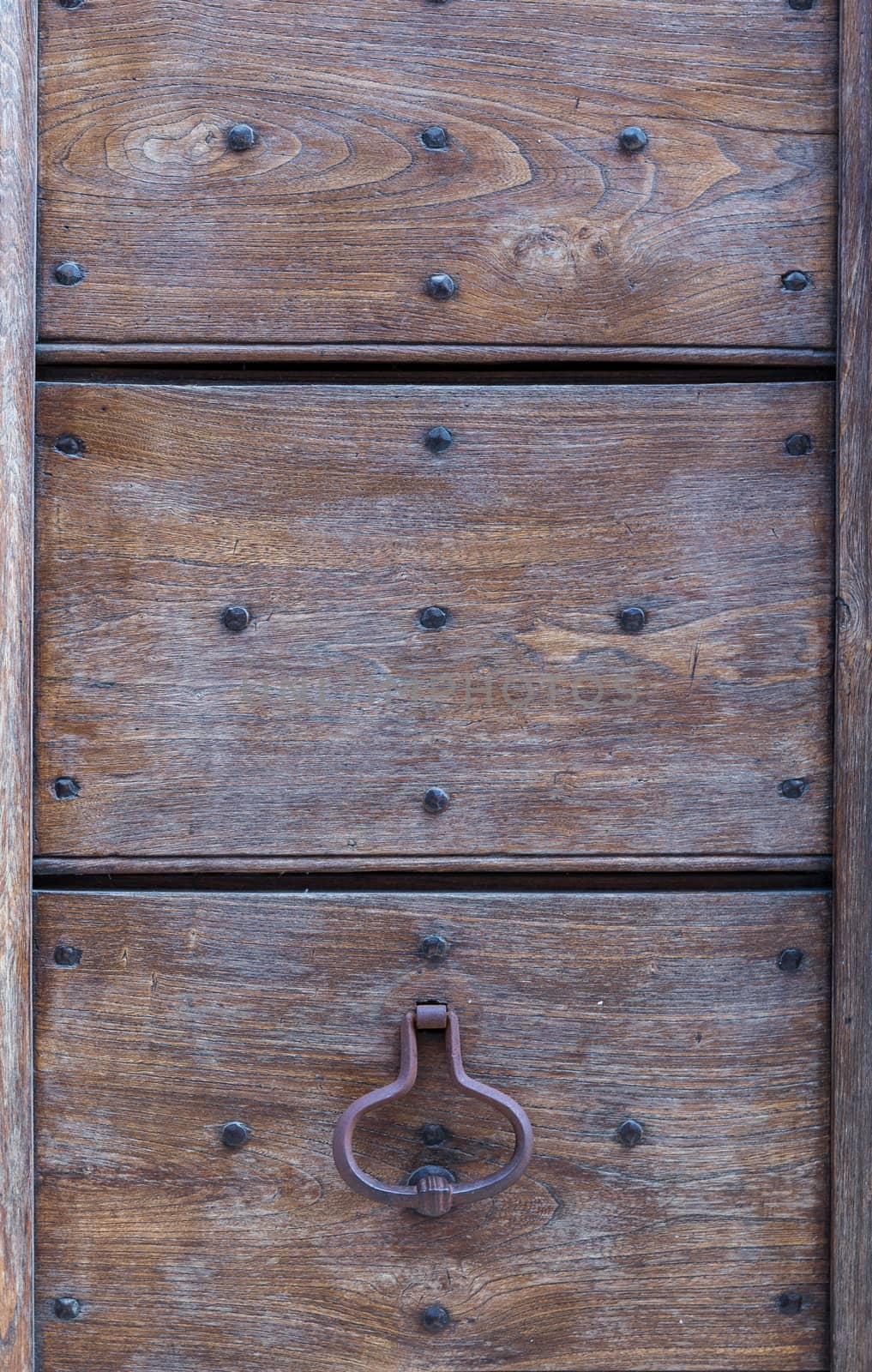 Close up of rustic old door in Spoleto, Italy.