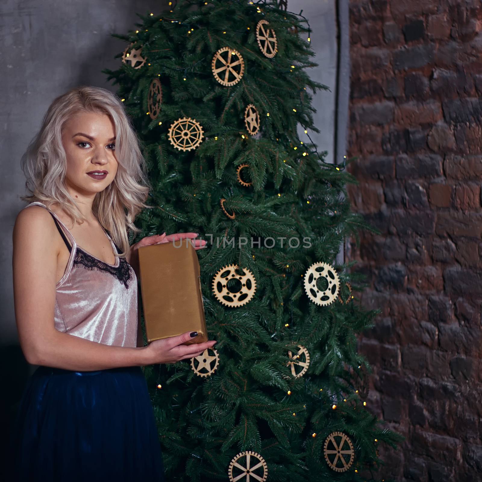 stylish happy woman decorating christmas tree by victosha
