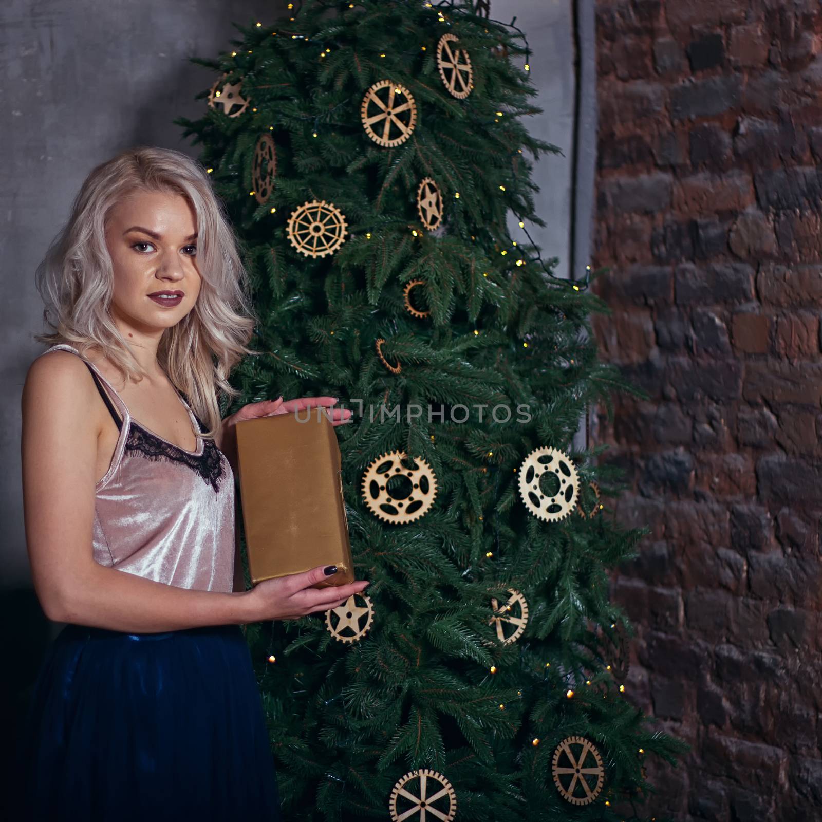 stylish happy woman decorating christmas tree.seasonal greetings concept