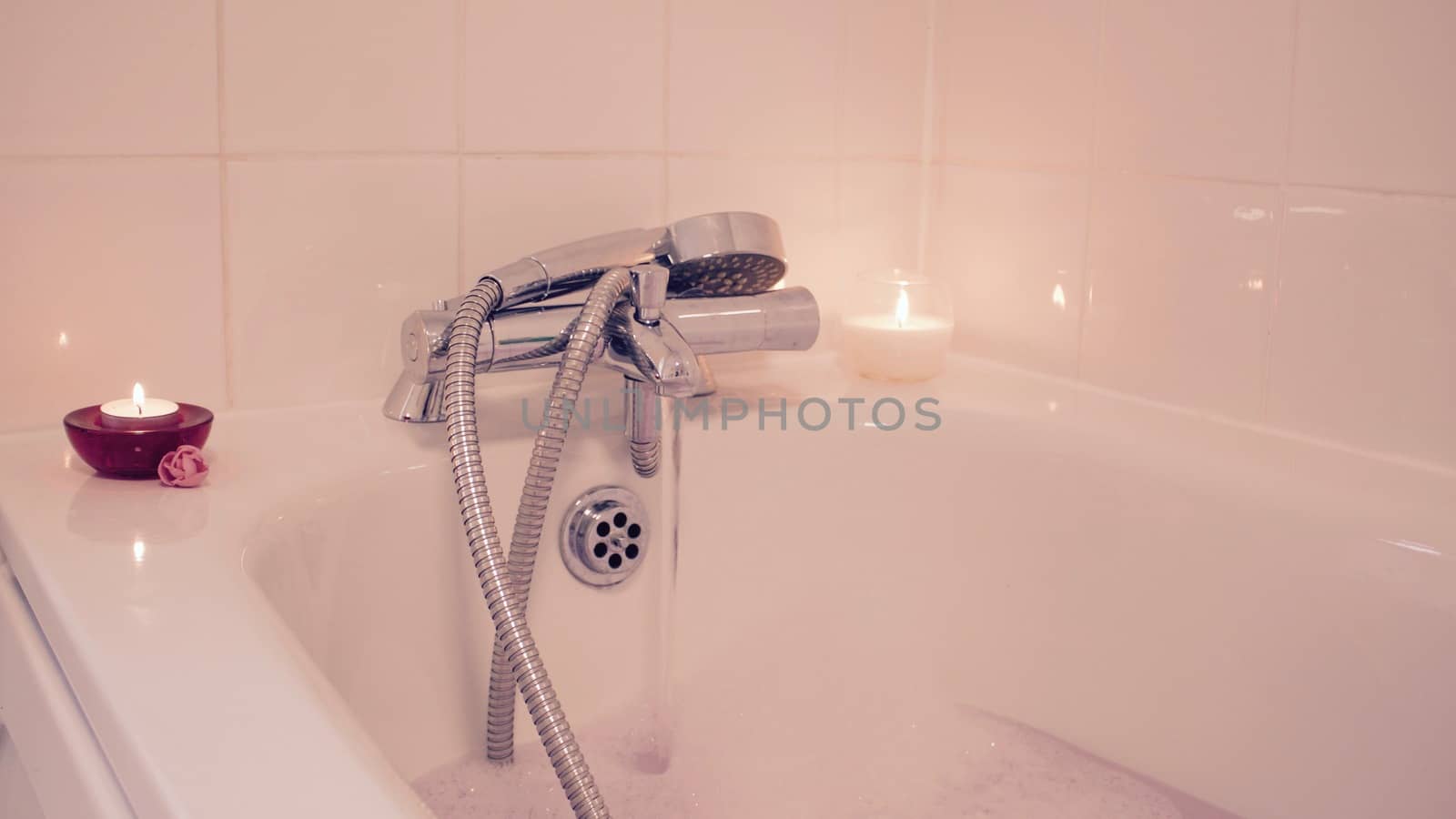 White and red candles in bathroom. Hot water and relax time at home.