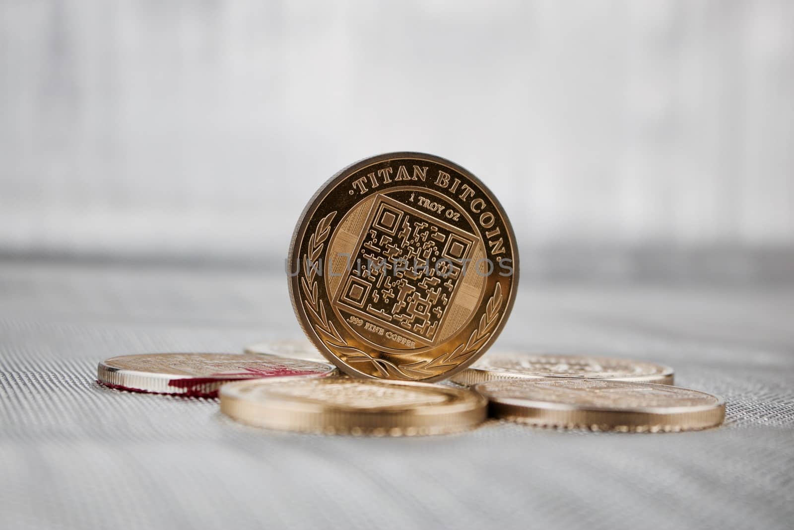 Digital currency physical gold titan bitcoin coin on the money. Business concept.