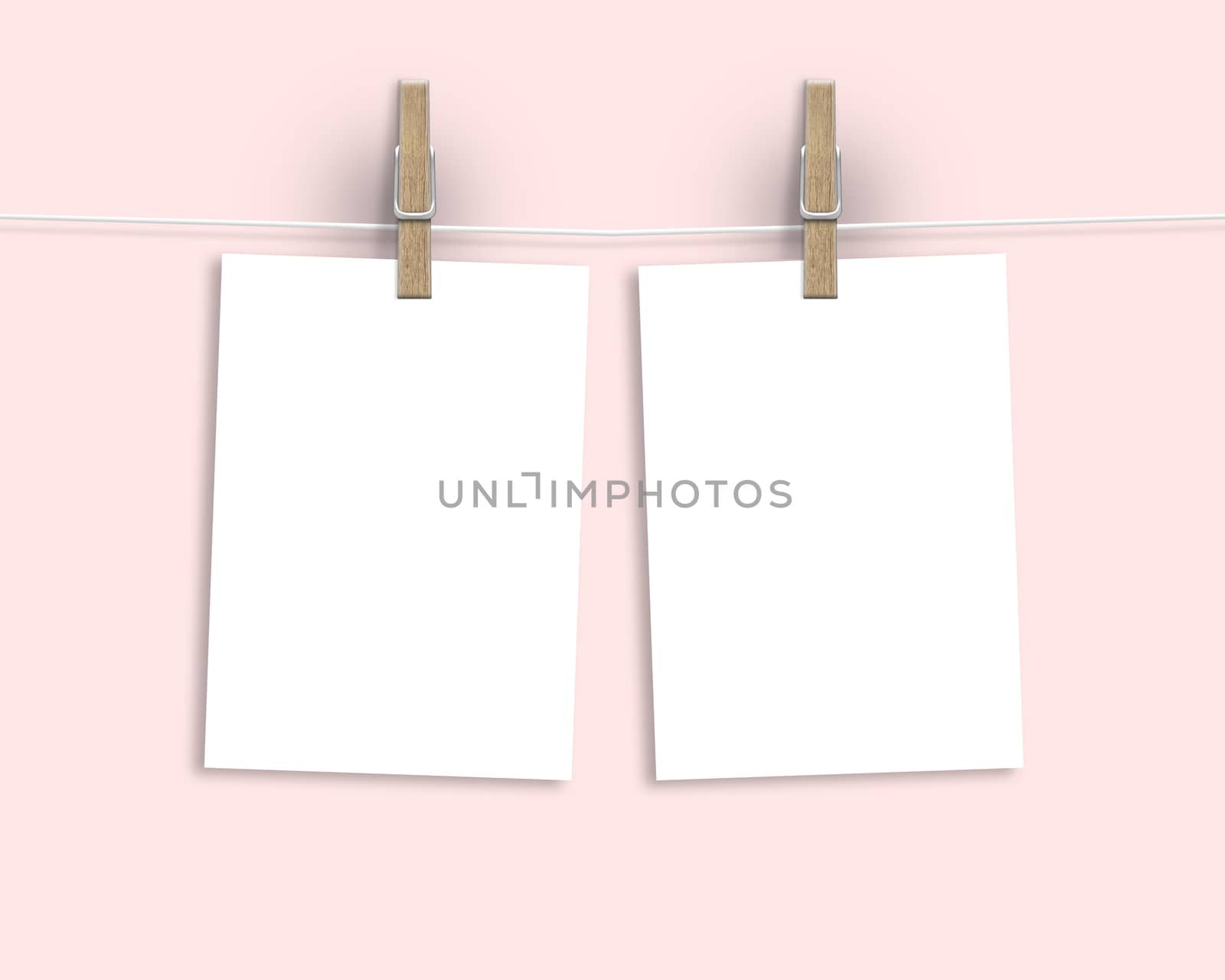 Paper cards hanging on a clothesline with clothespins on light background