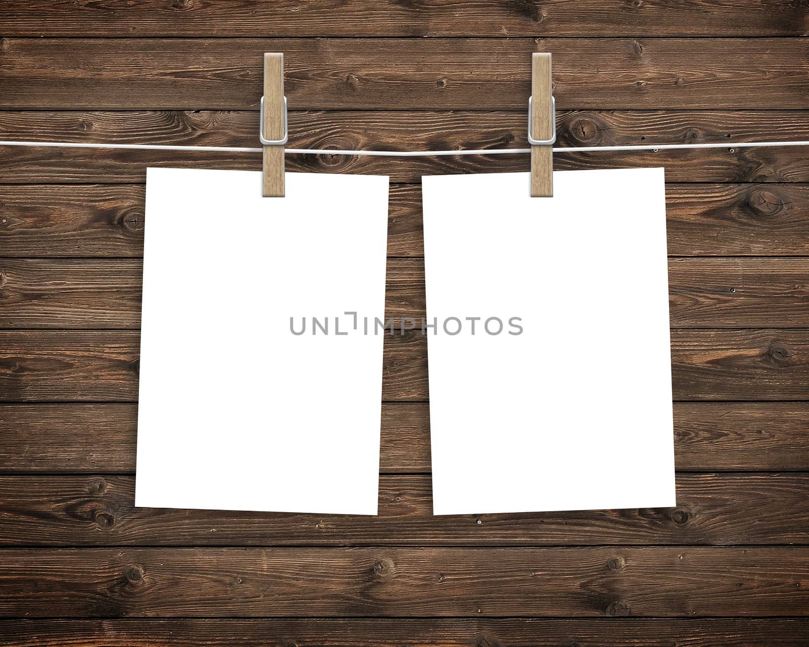 Paper cards hanging on a clothesline with clothespins on wood background by boys1983@mail.ru