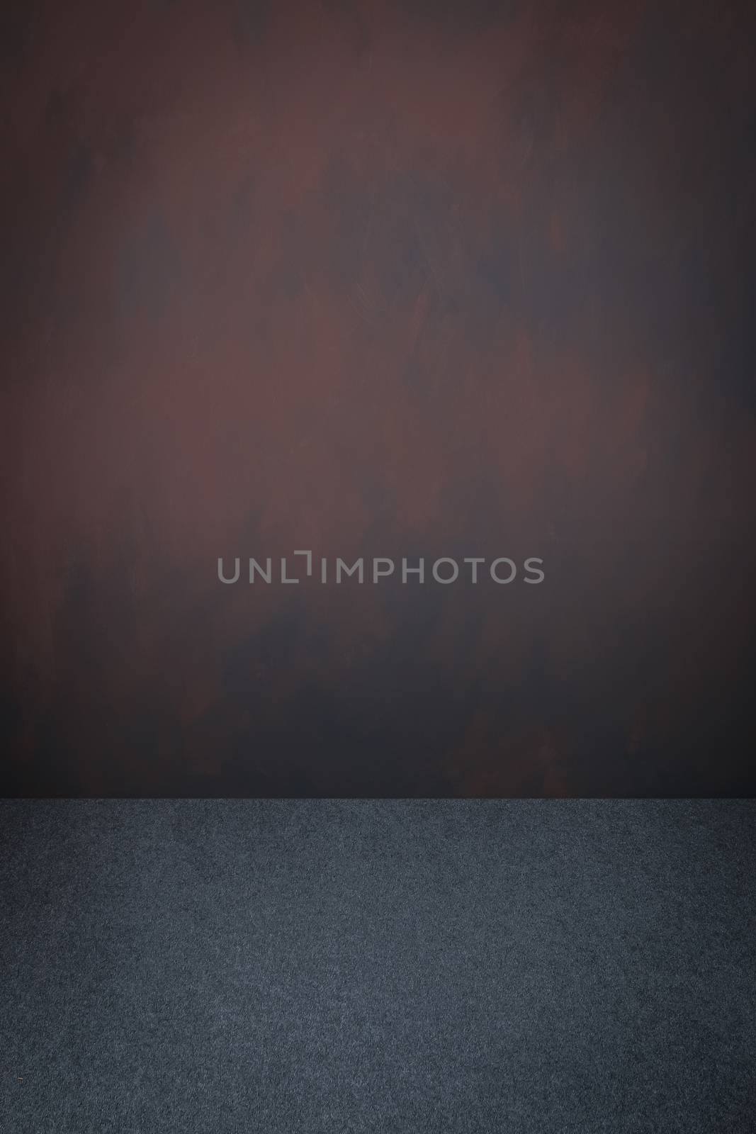 Grey carpet and dark brown grey grungy painted wall with vignette, use for background