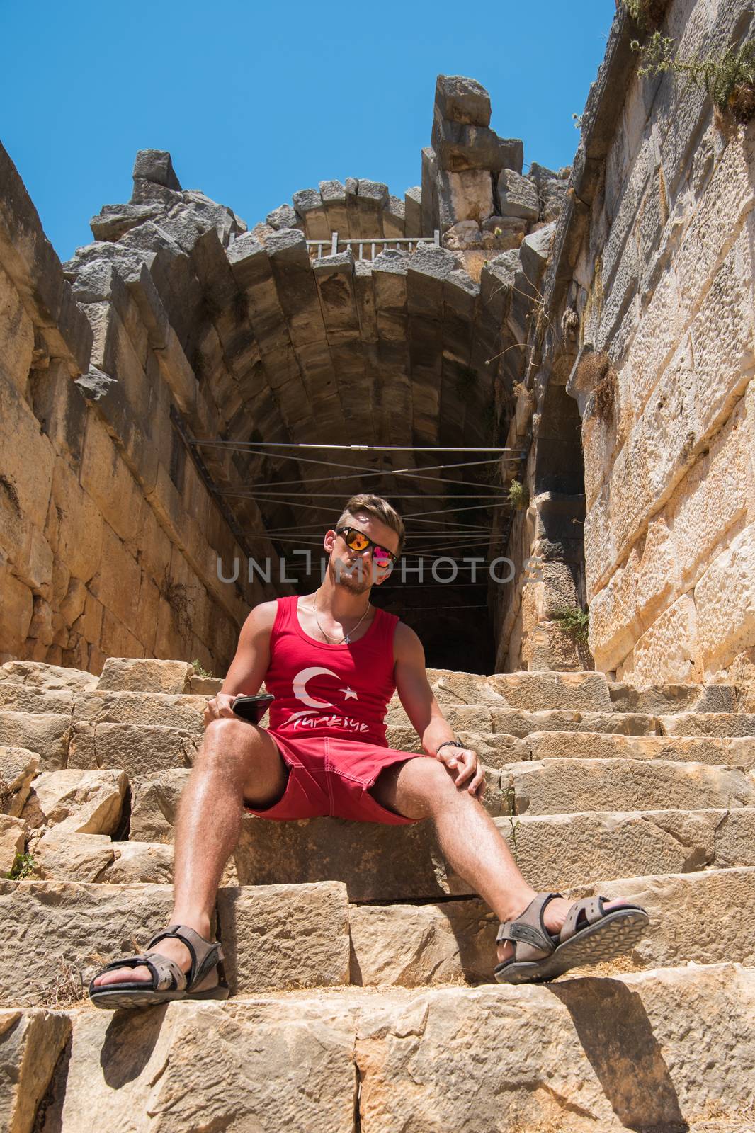 Young man at theatre in Myra ancient city of Antalya in Turkey.