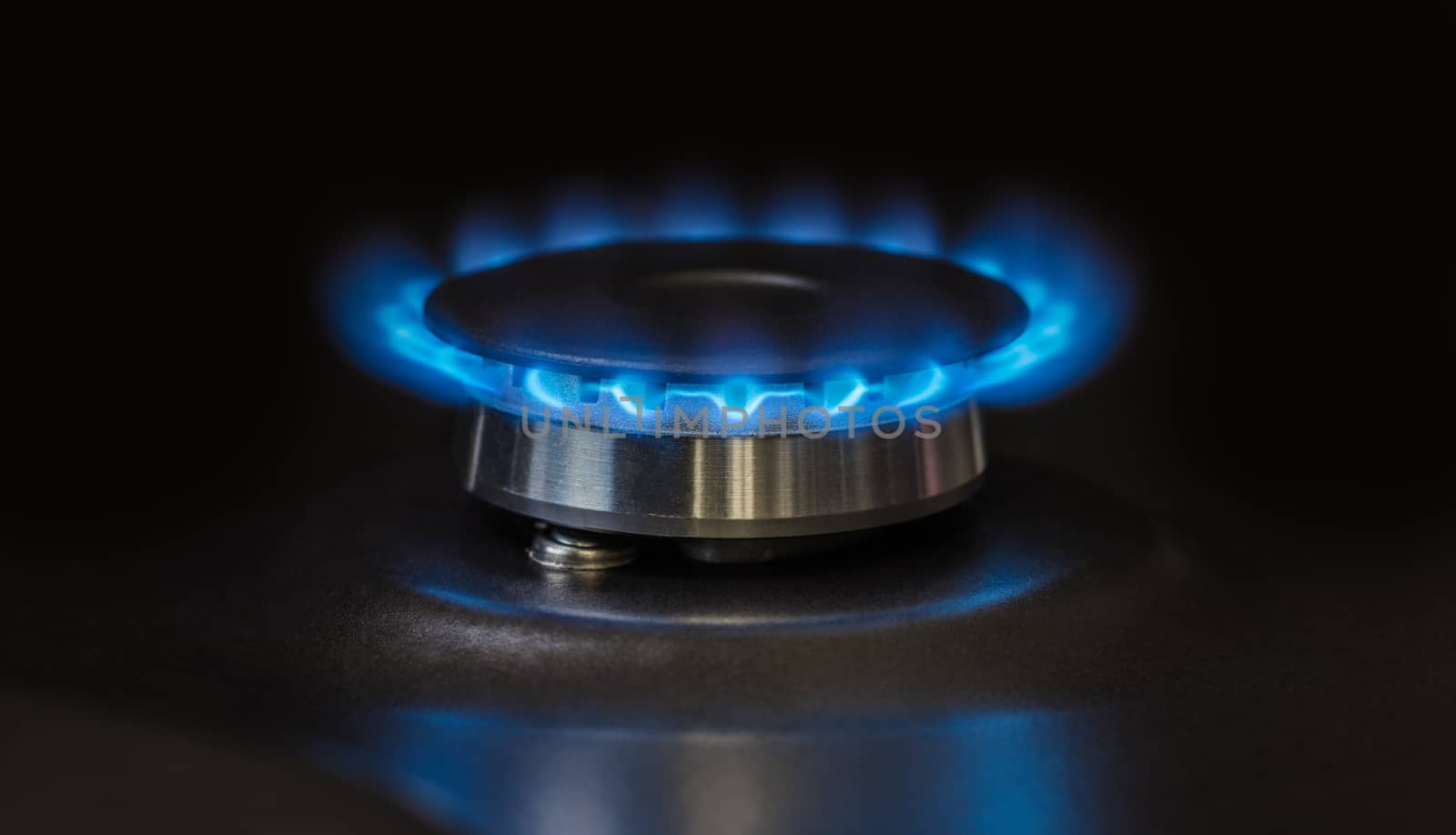 black kitchen gas stove burning burner close-up