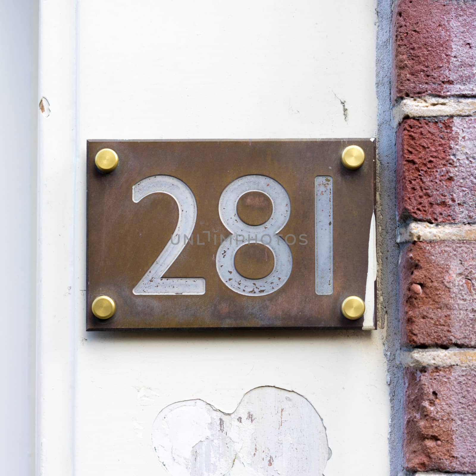 House number two hundred and eighty one (281) engraved in a bronze plate