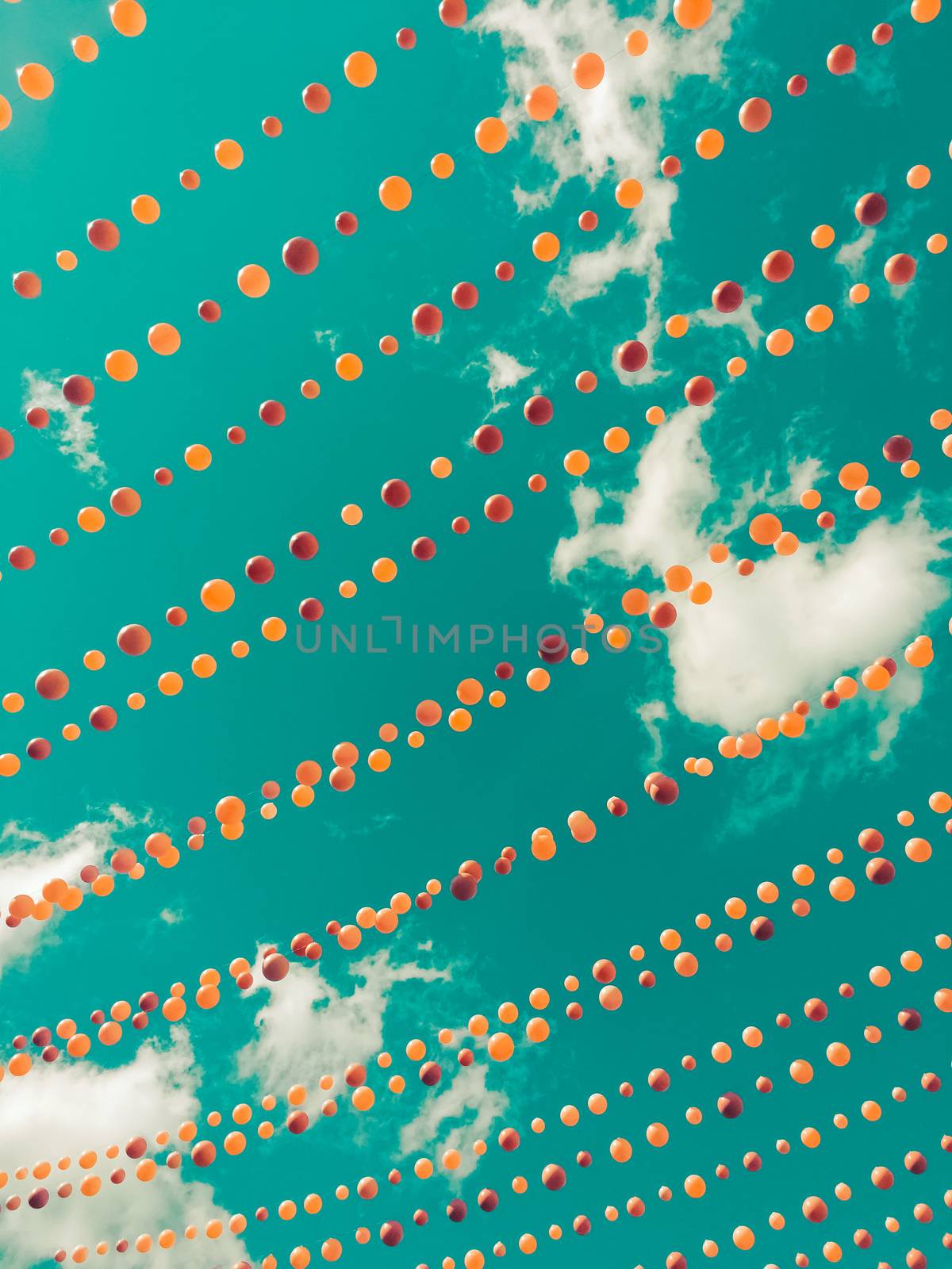 Vintage style image of colorful balls decoration against sky and clouds. Ste-Catherine street, gay village neighborhood in Montreal (Quebec, Canada).