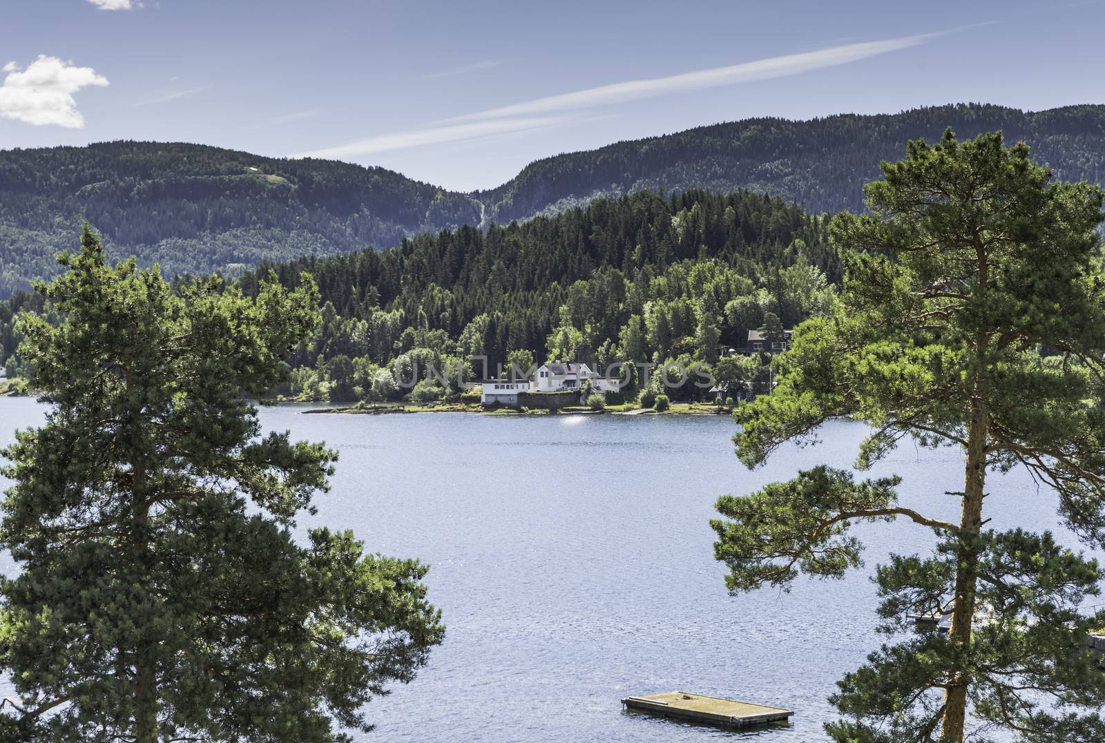 Utoya island with green forest and a house in norway near Oslo where Breivik shot a lot of students in 2011