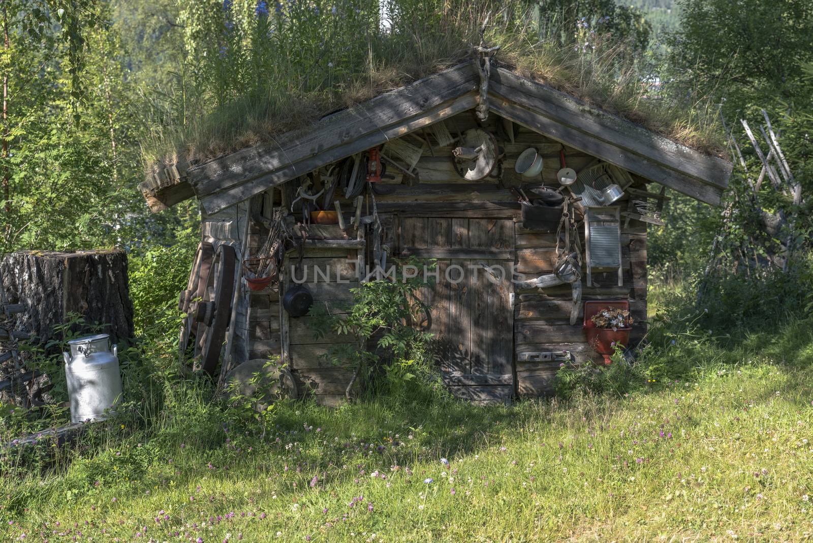 old wooden house with a lot of zink equipment like pots,pans and other