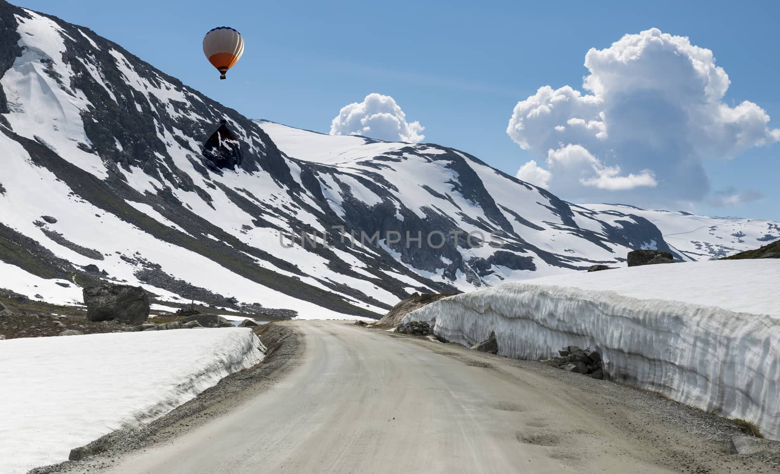 hot air balloon above the snow in summer on the gamle strynefjellsvegen one of the most beautifull auto roads in norway with snow in summer 