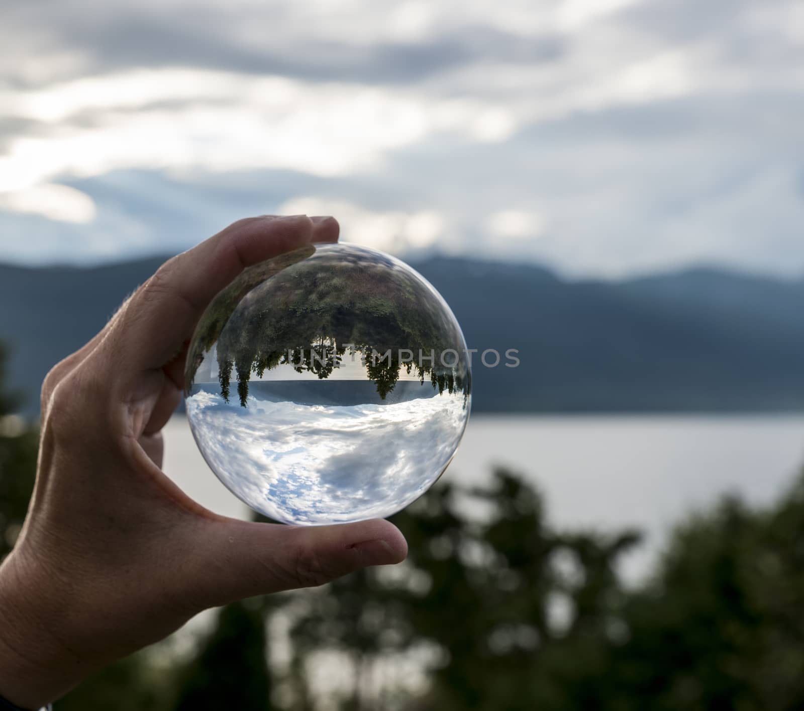 sognefjord with reflection of the fjord in glass sphere