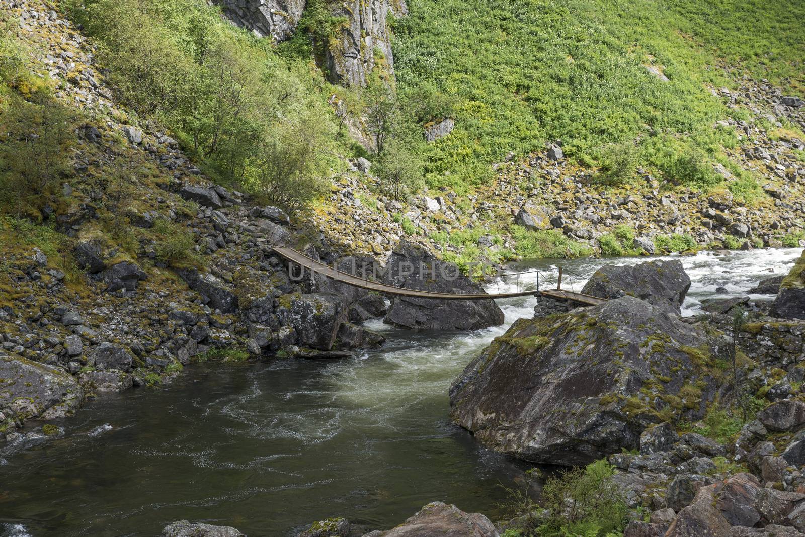 bridge at the walking track to the voringfossen waterfall by compuinfoto