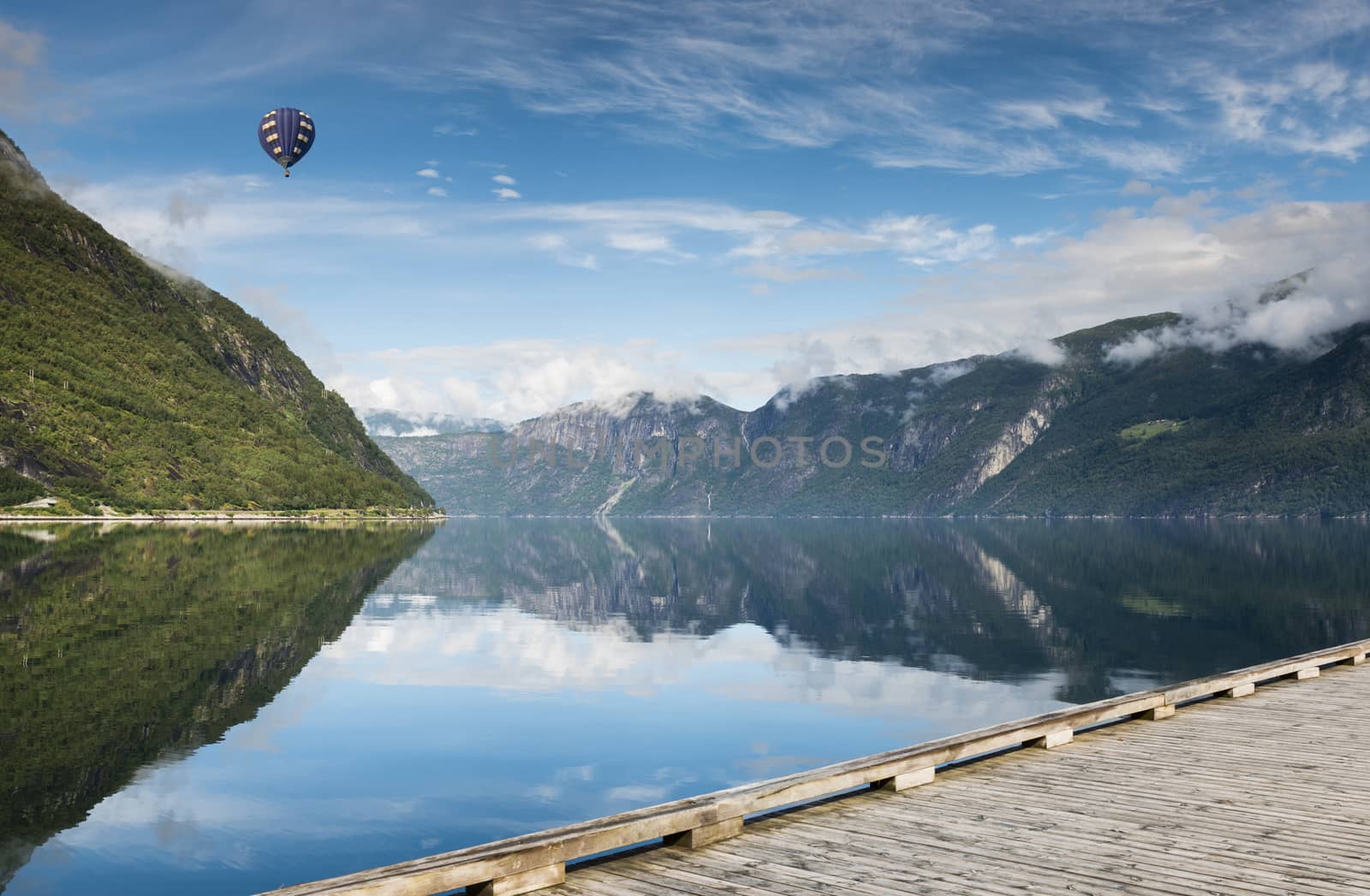 reflection of mountains in fjord in norway by compuinfoto