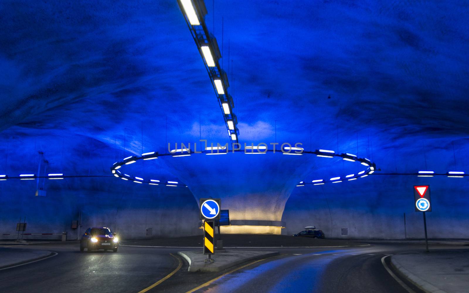 A roundabout in the Vallavik Tunnel in Granvin in Norway, Laedal Tunnel is a 24.51 kilometre long road tunnel connecting Laerdal and Aurland in Norway background.