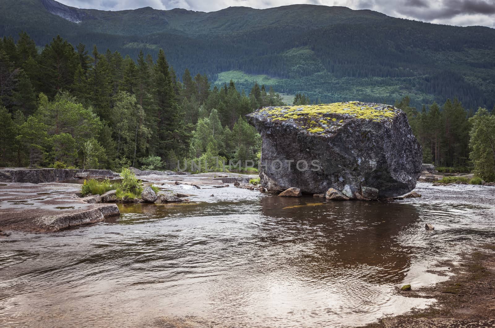 big rock in river in norway by compuinfoto