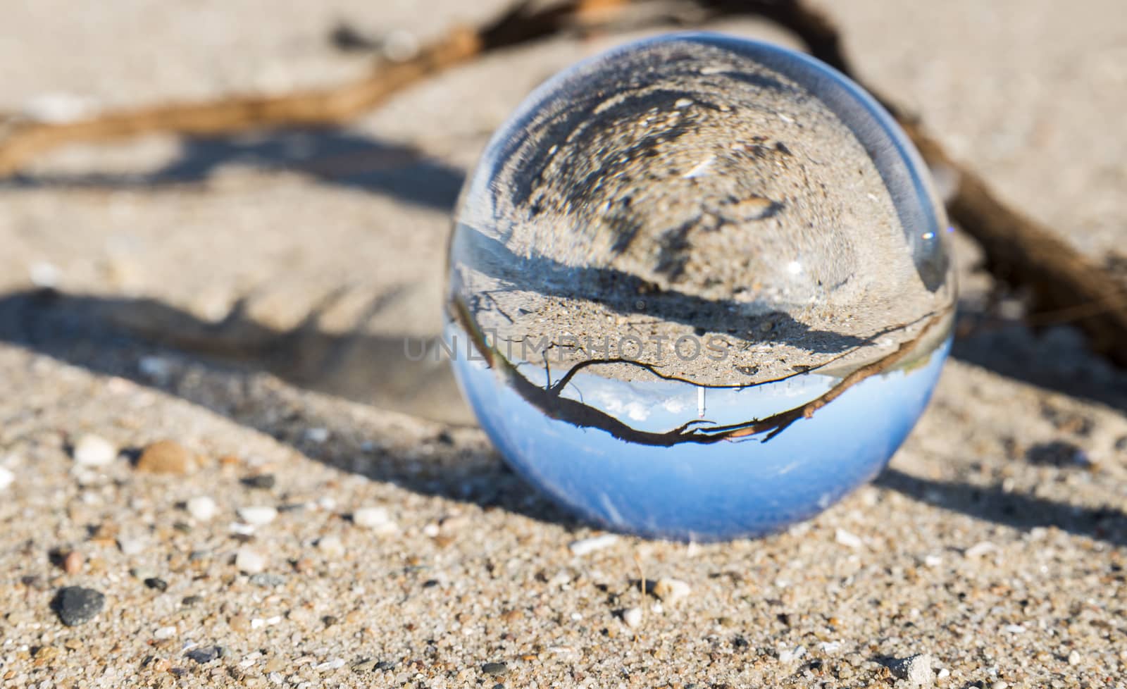glass sphere with hellevoetsluis lighthouse from the beach