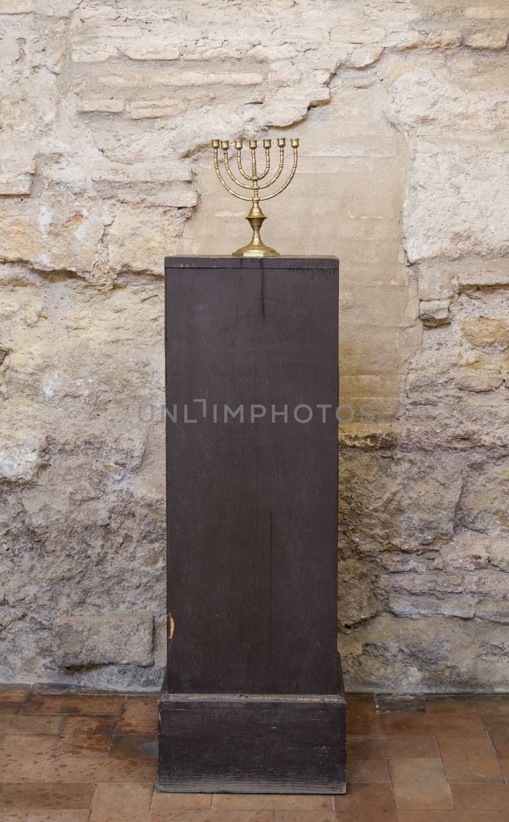 old religious menorah with ancient wall