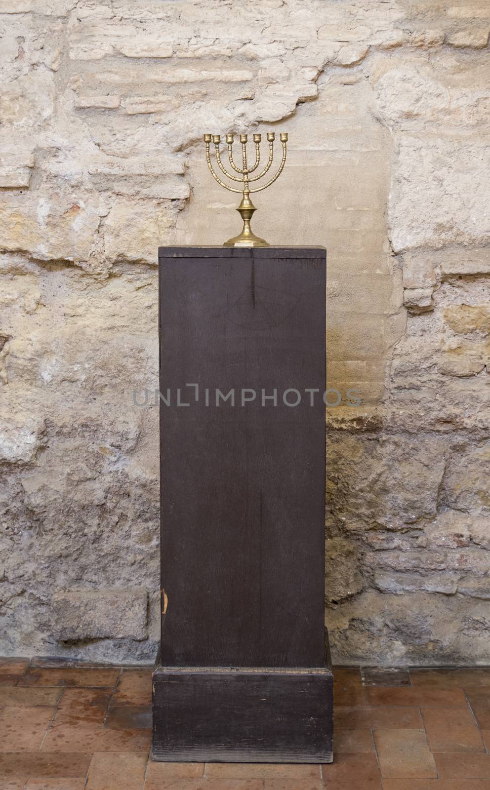 old religious menorah with ancient wall