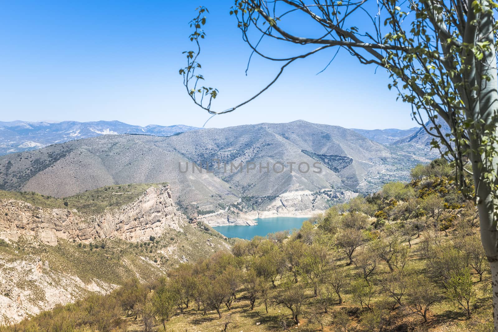 blue lake and hills in the sierra nevada in andalusia spain in summer