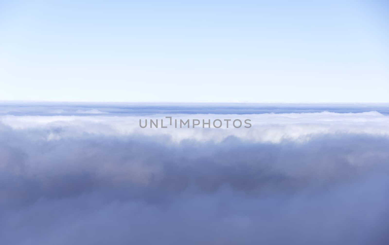 blue sky and clouds on the horizon from airplane view