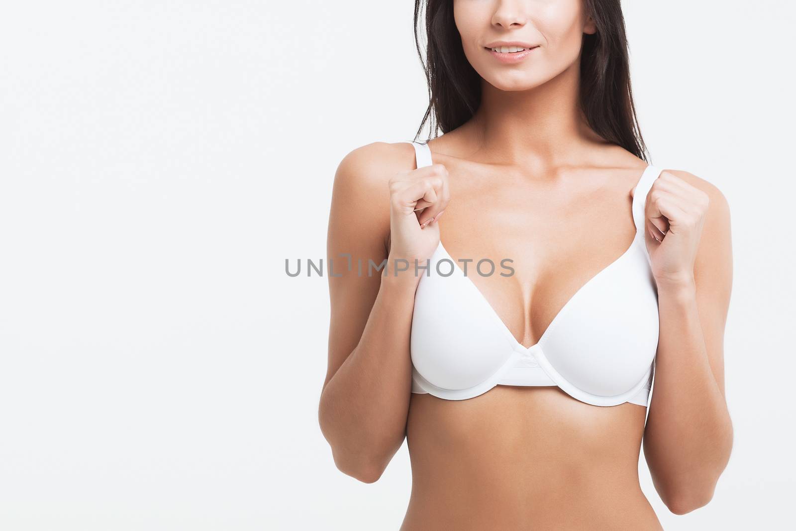 Woman breast in uplift on a white background