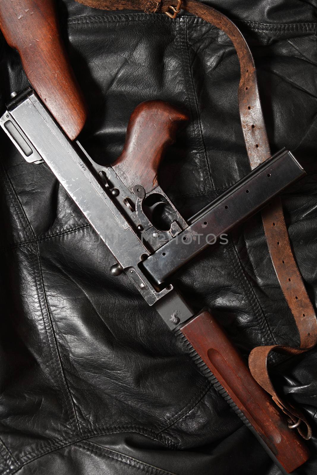 Old USA submachine gun closeup on black leather background