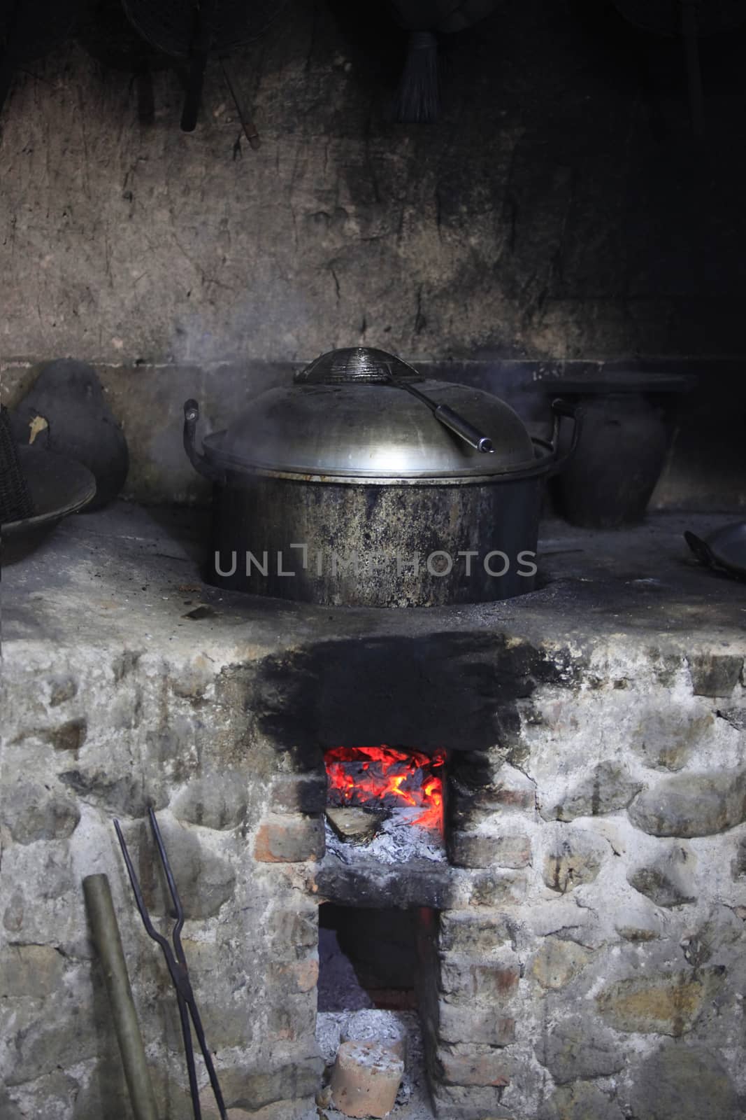An old stone stove with an old saucepan. China