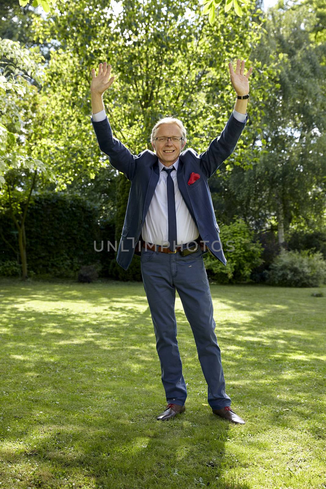 Shot of gesticulate man in the garden at sunny day. Natural sunlight.