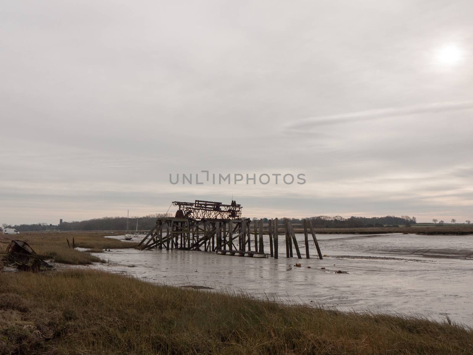 wooden sea structure moody overcast grey sky river estuary; essex; england; uk