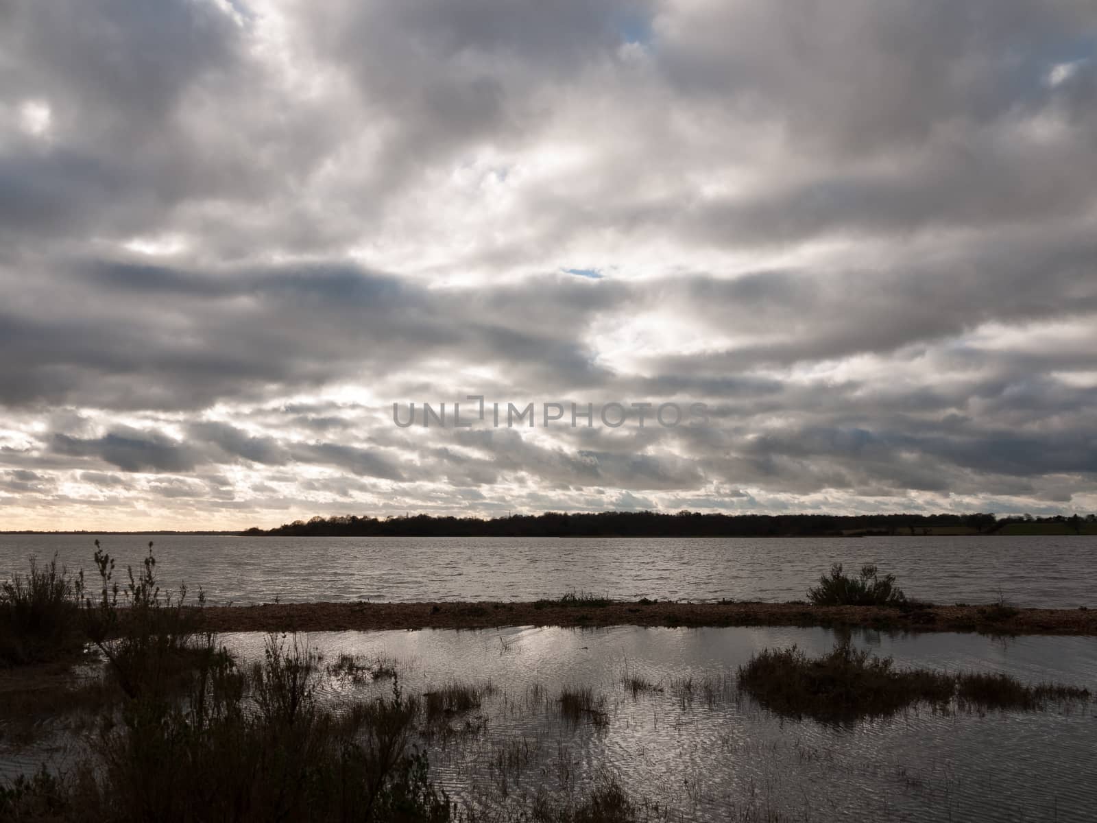 moody sky overcast autumn winter bay water ocean trees; essex; england; uk