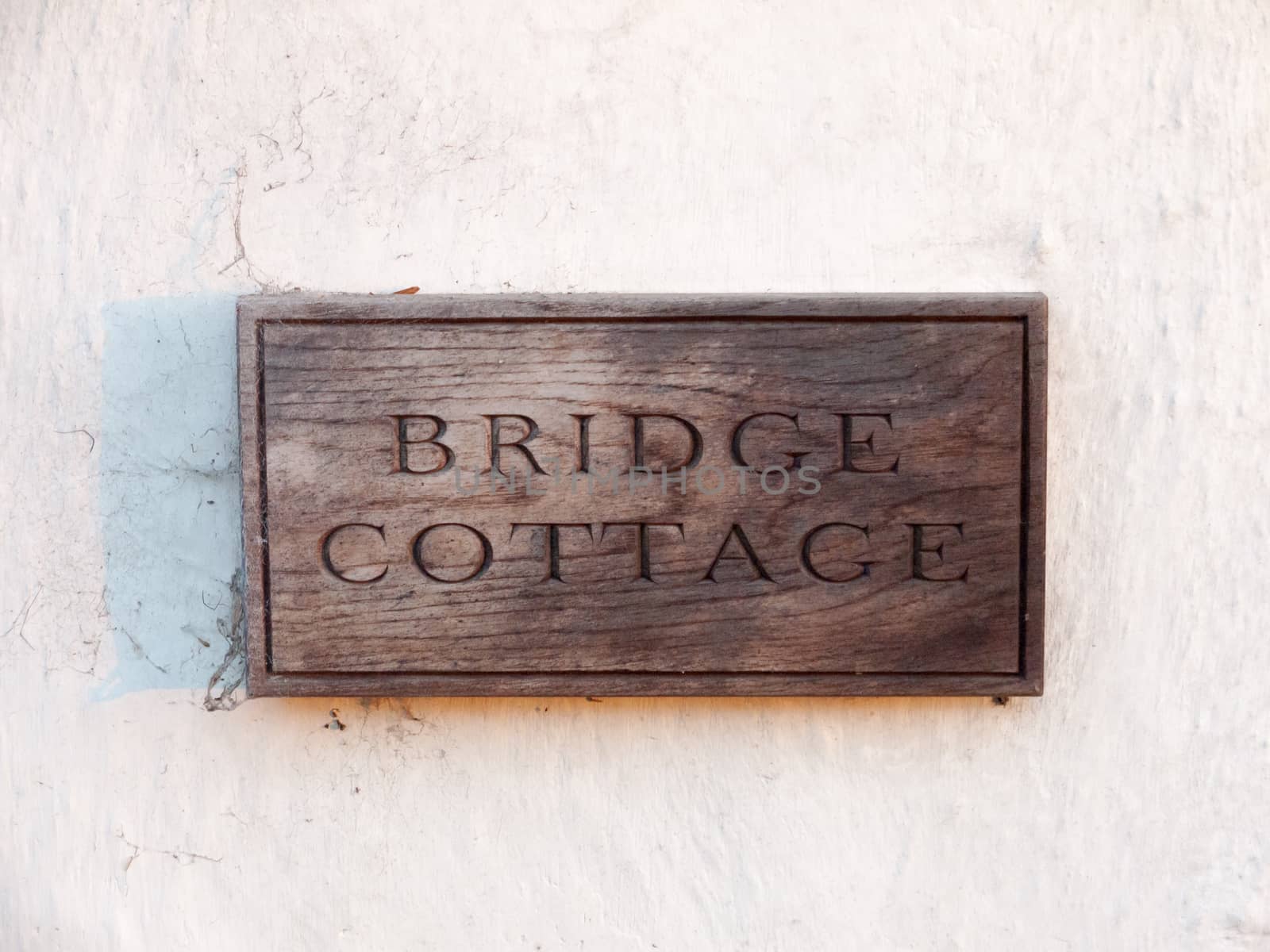 close up wooden house sign bridge cottage carved special unique; essex; england; uk