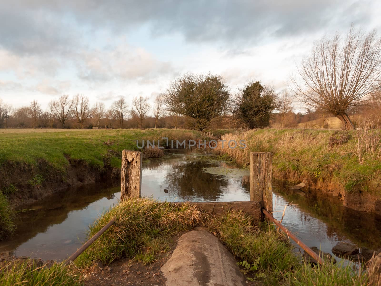 wet waterlogged country farm land stream eddy ; essex; england; uk